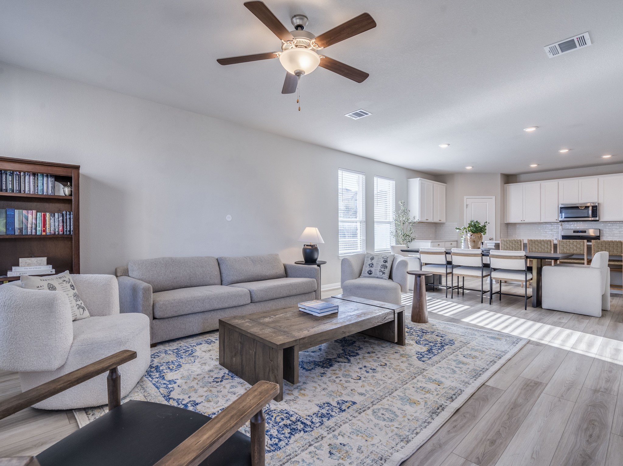 218 Glass Mountain Way Dripping Springs, TX 78620 - Photo 8 of 29 a living room with furniture a rug and a chandelier