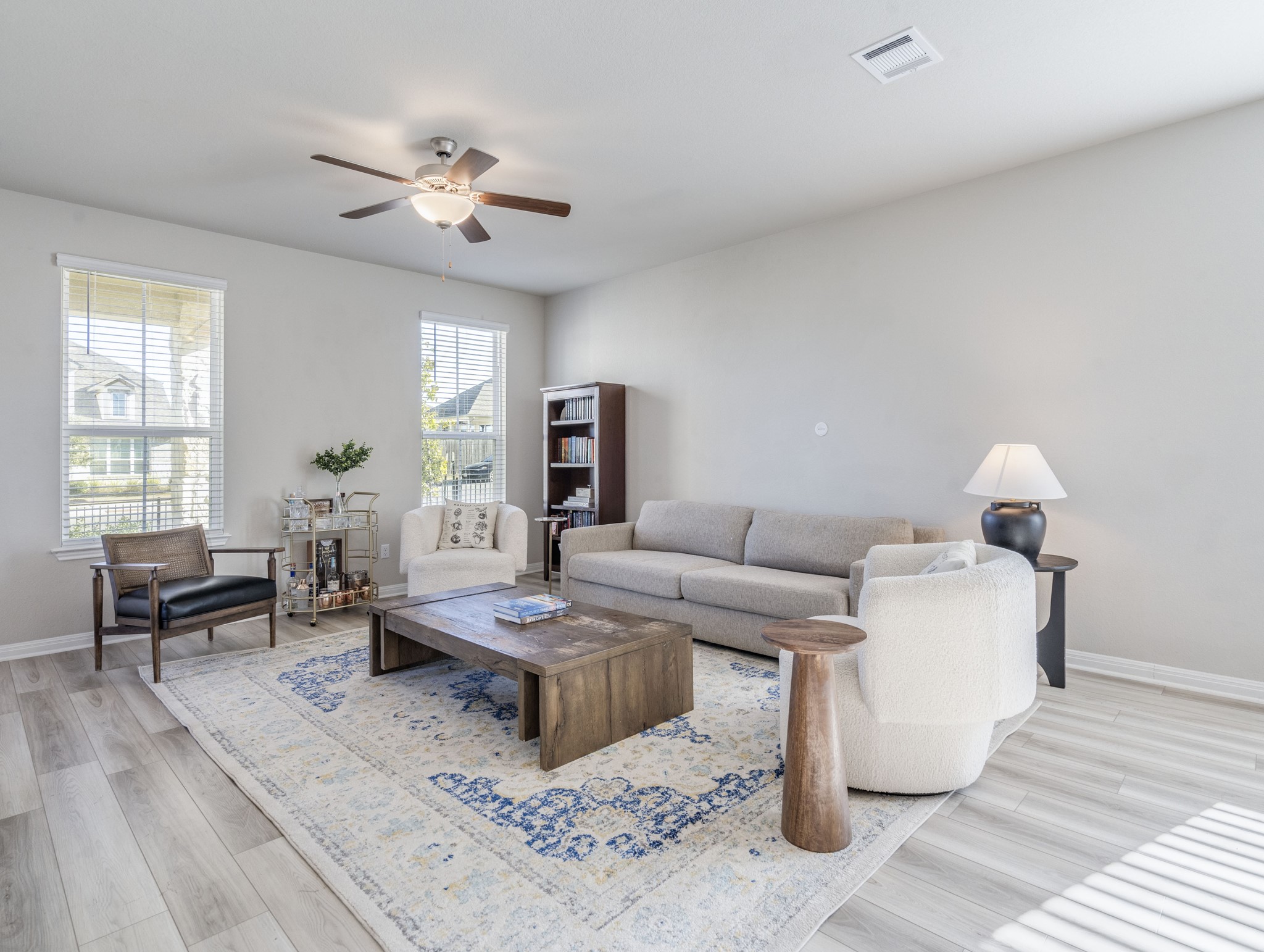 218 Glass Mountain Way Dripping Springs, TX 78620 - Photo 10 of 29 a living room with couches and kitchen view with wooden floor