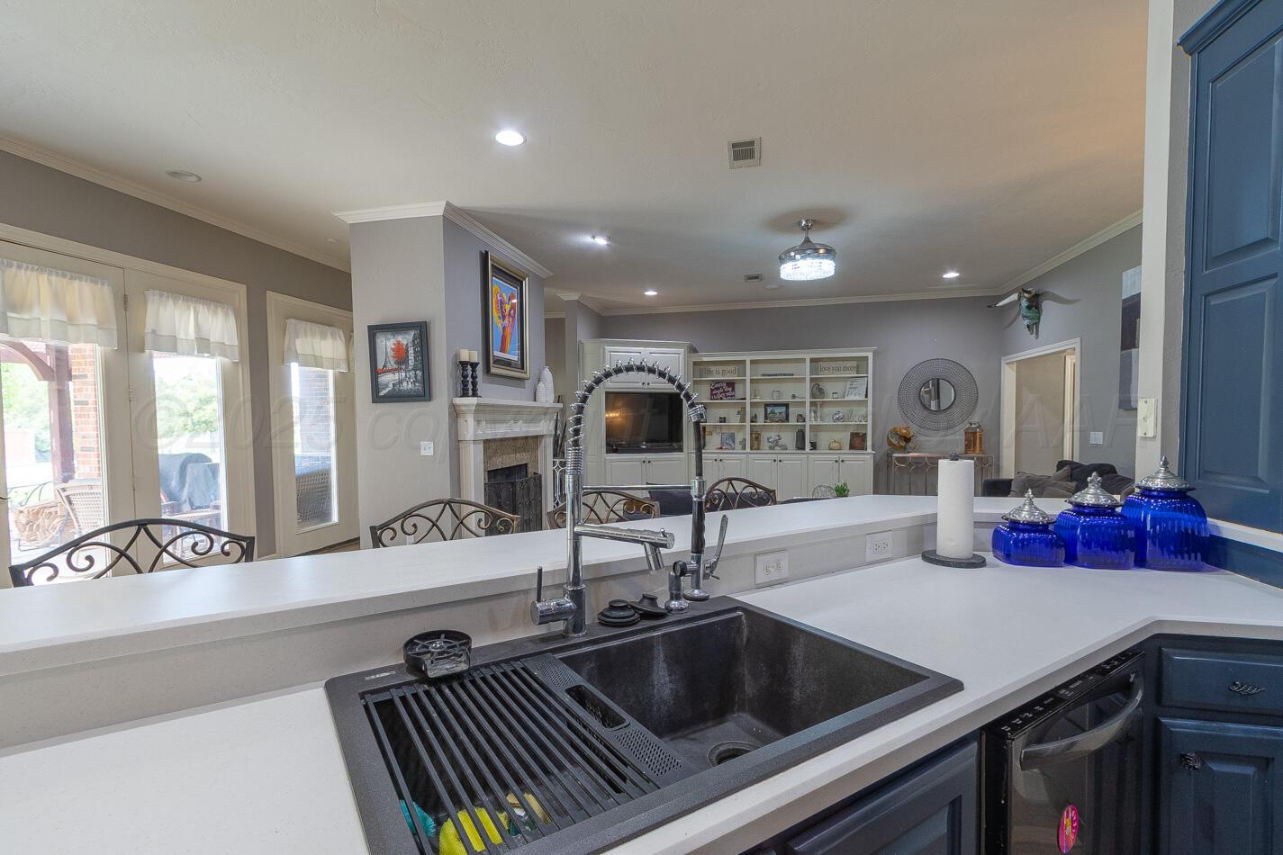 7500 Bayswater Road Amarillo, TX 79119 - Photo 12 of 46 a kitchen with a sink and a refrigerator