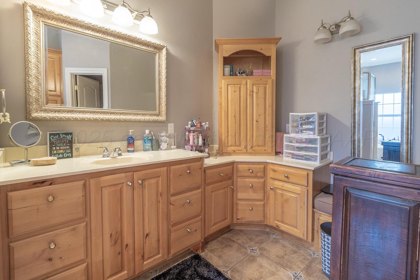 7500 Bayswater Road Amarillo, TX 79119 - Photo 16 of 46 a spacious bathroom with a double vanity sink mirror and