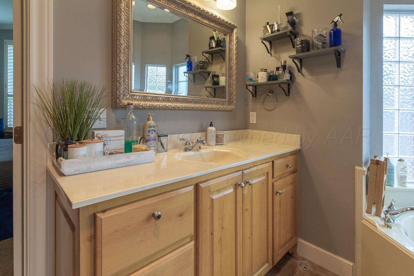7500 Bayswater Road Amarillo, TX 79119 - Photo 17 of 46 a bathroom with a sink and a mirror