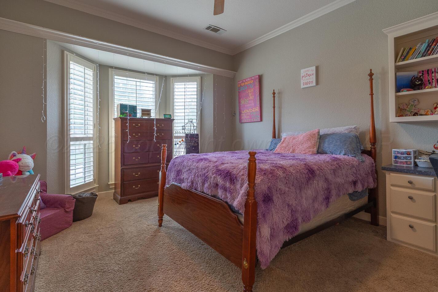 7500 Bayswater Road Amarillo, TX 79119 - Photo 18 of 46 a bedroom with a bed and dresser