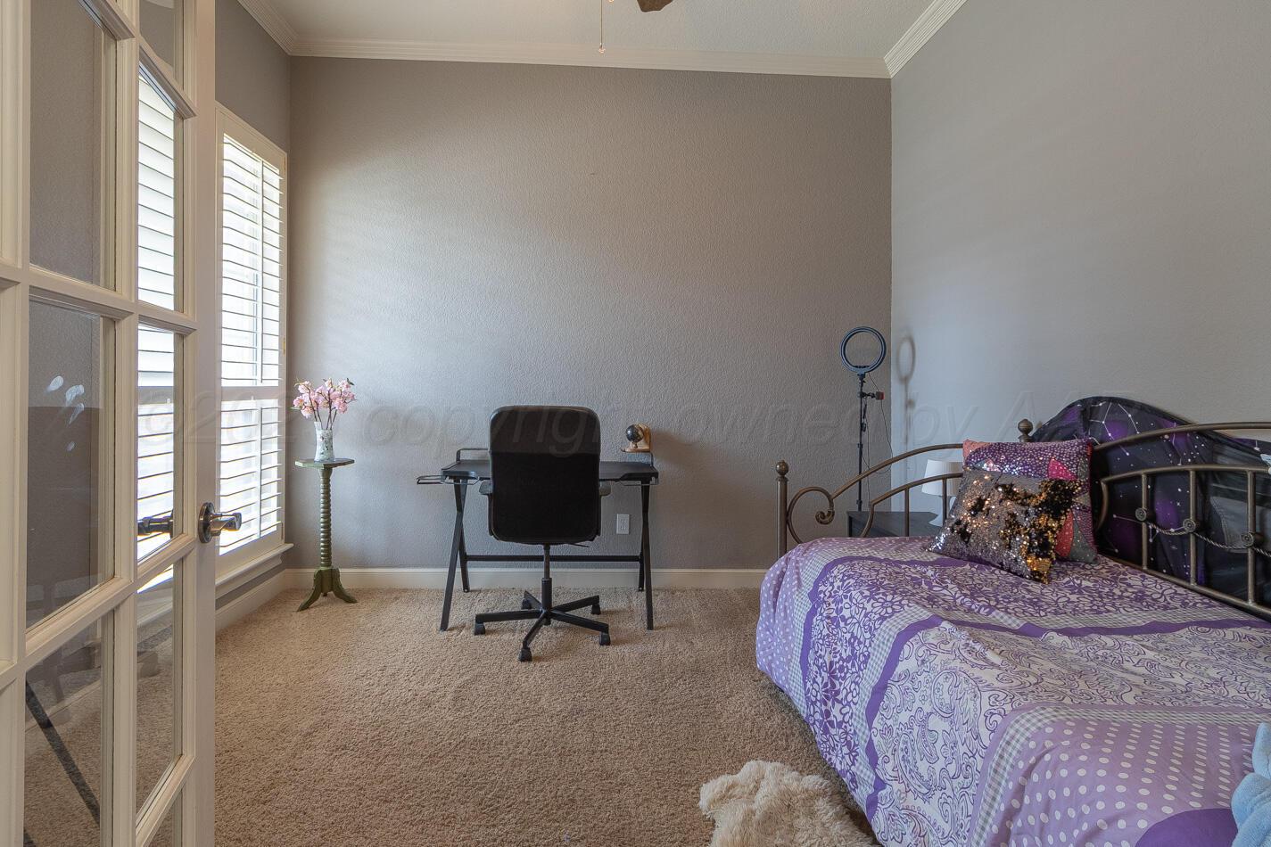 7500 Bayswater Road Amarillo, TX 79119 - Photo 22 of 46 a bedroom with a bed chair and a window