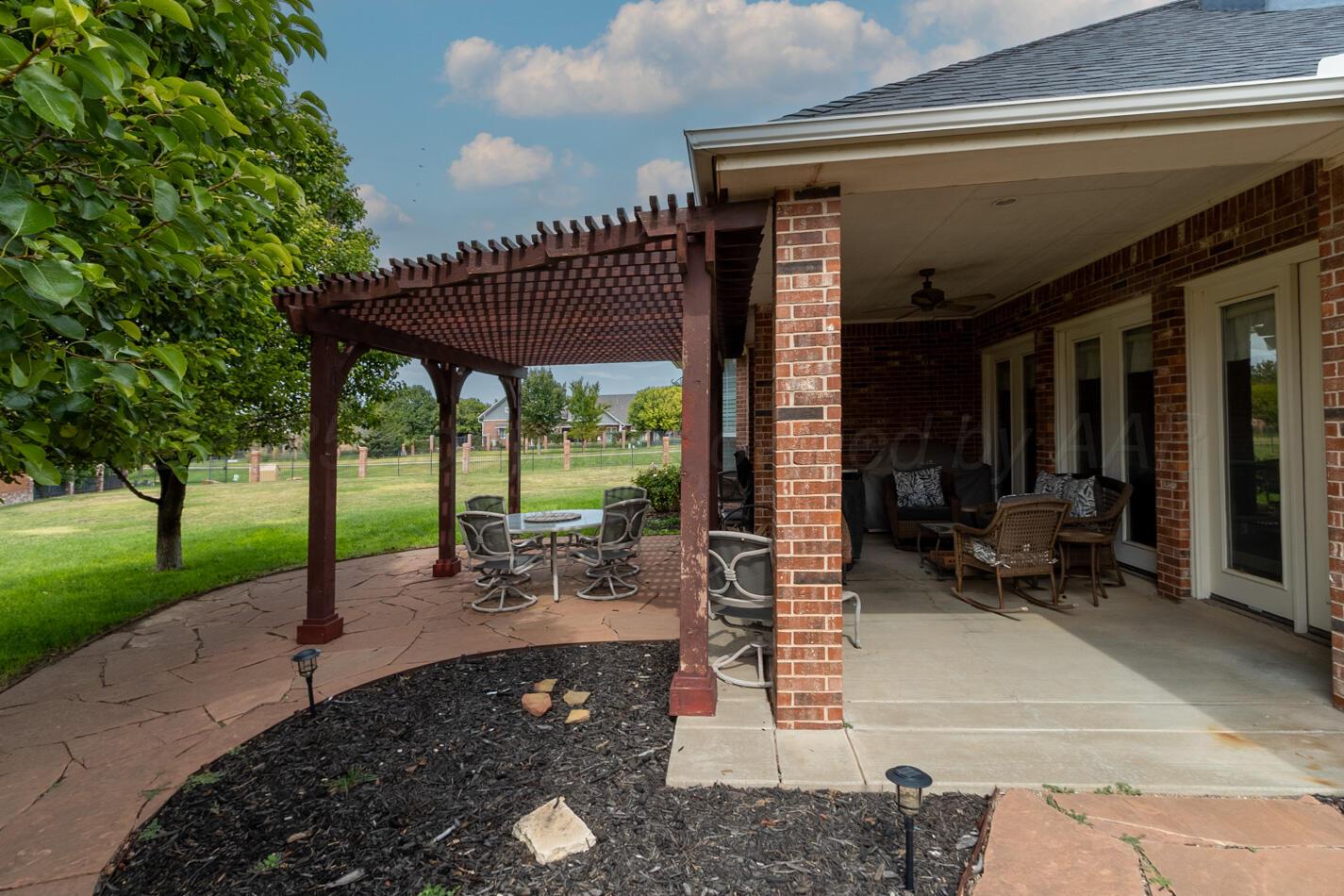 7500 Bayswater Road Amarillo, TX 79119 - Photo 26 of 46 a view of a patio with a table chairs and a backyard