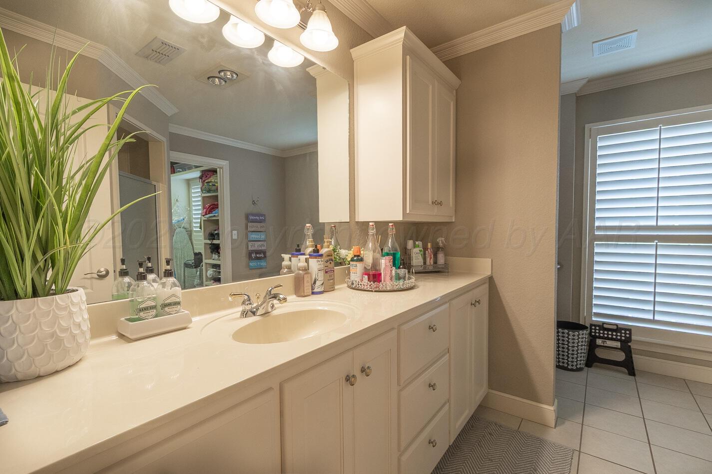 7500 Bayswater Road Amarillo, TX 79119 - Photo 31 of 46 a bathroom with a sink a vanity and a mirror
