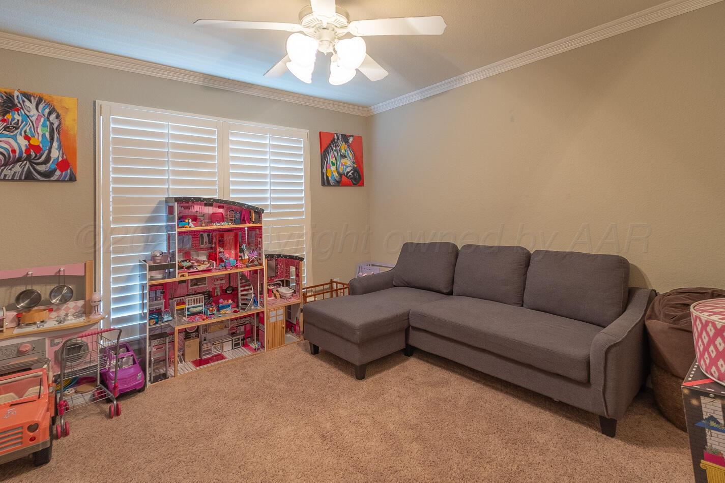 7500 Bayswater Road Amarillo, TX 79119 - Photo 32 of 46 a living room with furniture and a flat screen tv