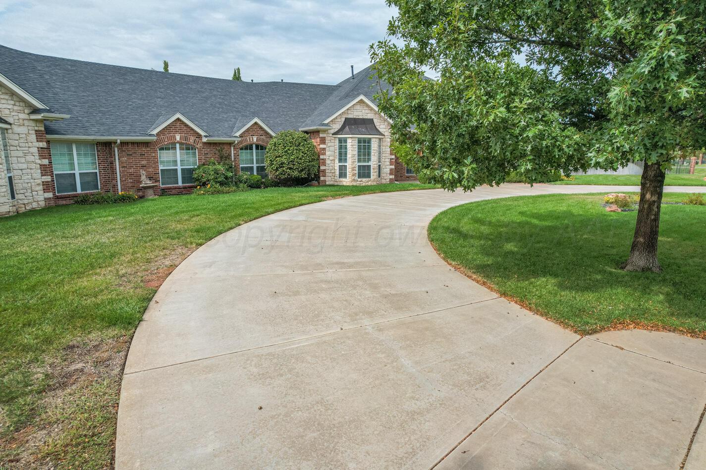 7500 Bayswater Road Amarillo, TX 79119 - Photo 37 of 46 a view of a big house with a big yard plants and large trees