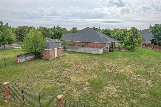 an aerial view of a house with porch yard basket ball court and trampoline