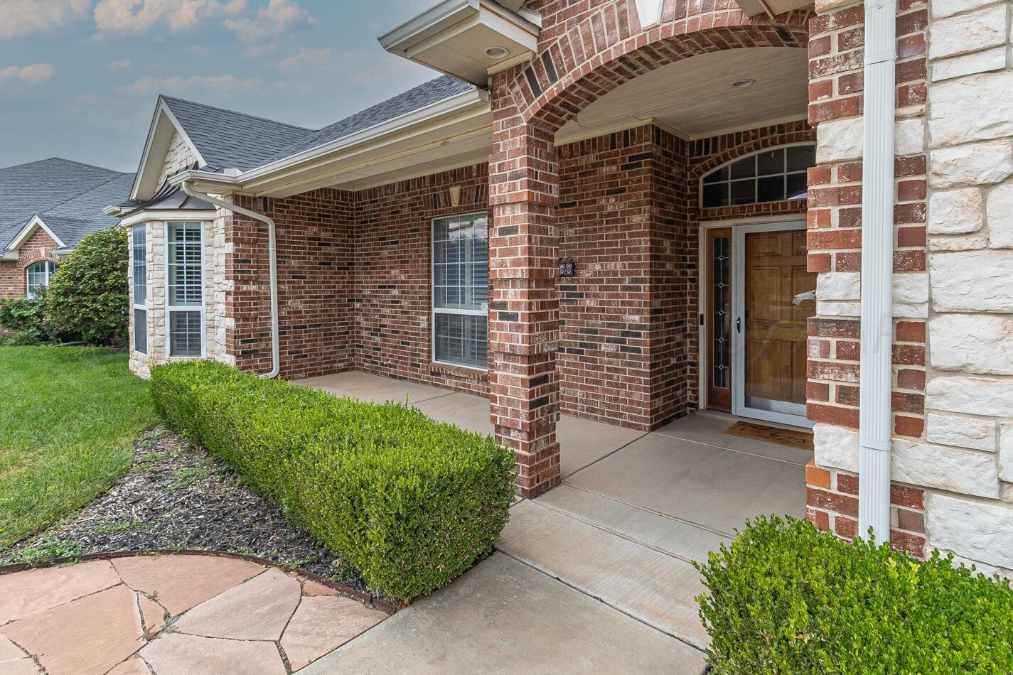 7500 Bayswater Road Amarillo, TX 79119 - Photo 4 of 46 front view of a house with a garden