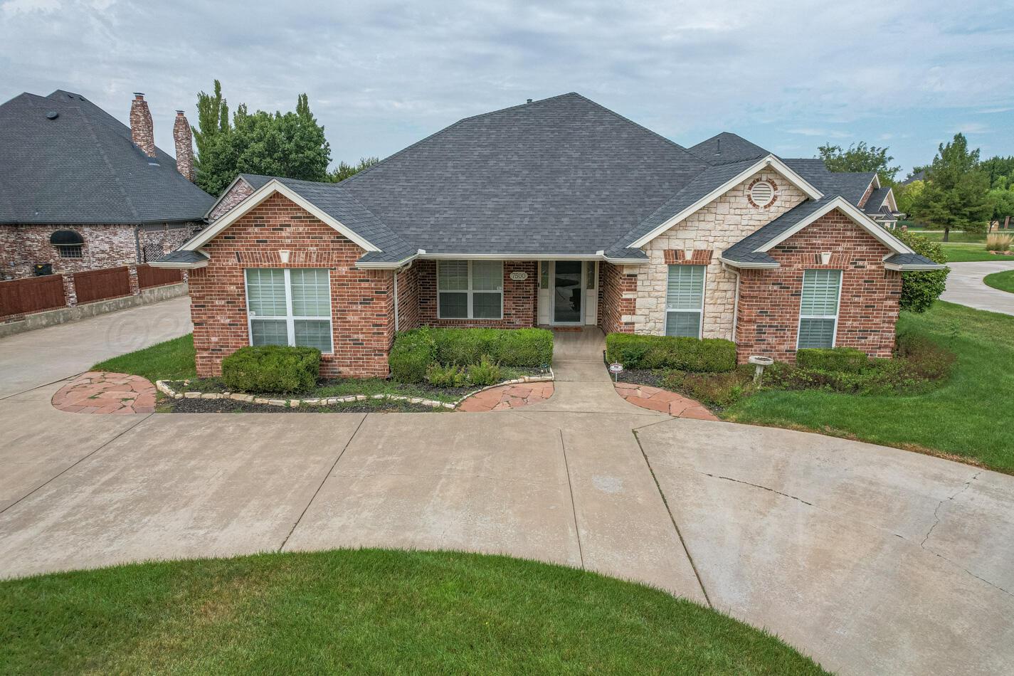 7500 Bayswater Road Amarillo, TX 79119 - Photo 5 of 46 a front view of a house with a yard and potted plants