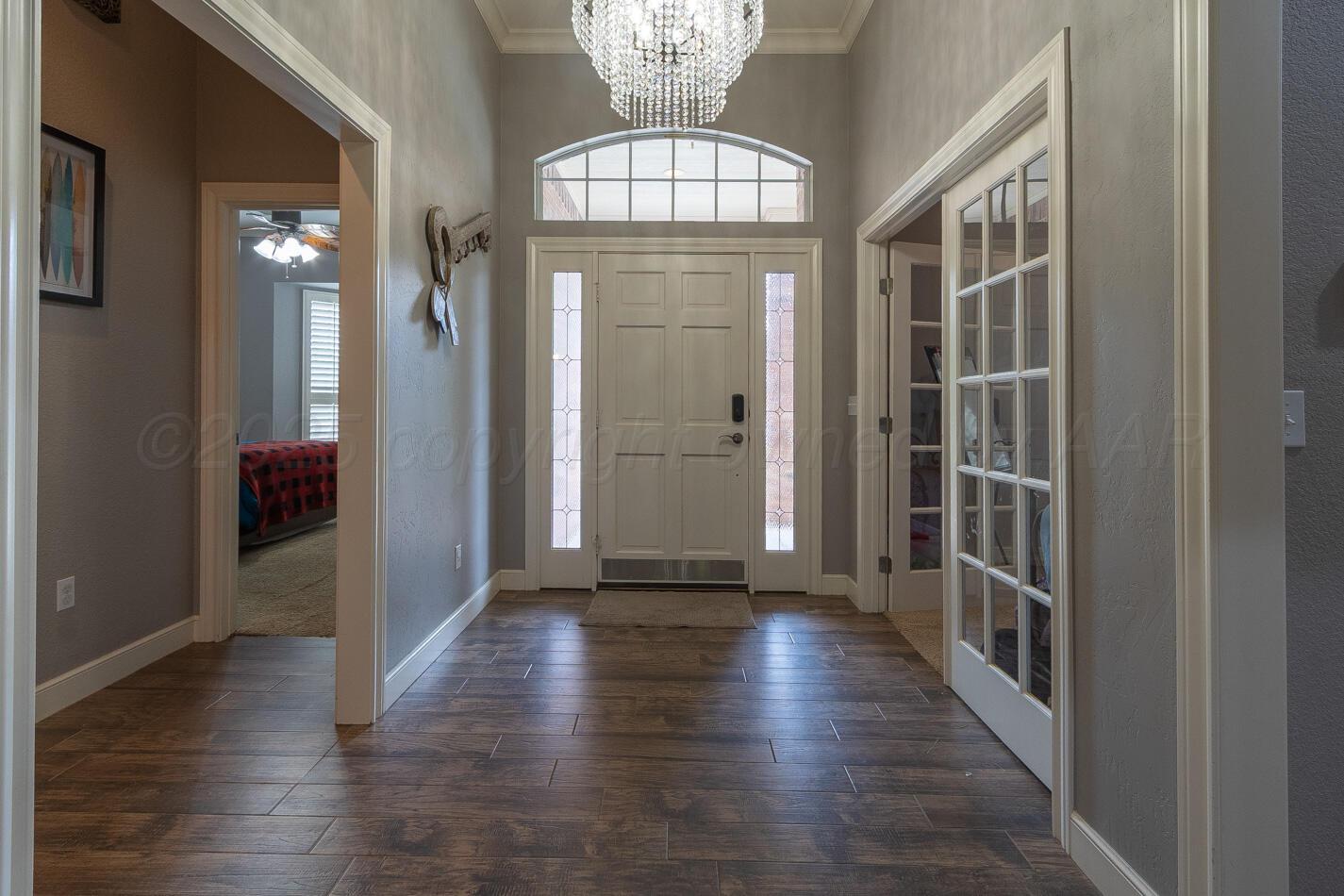 7500 Bayswater Road Amarillo, TX 79119 - Photo 6 of 46 a view of a hallway with wooden floor and stairs