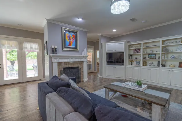 a living room with furniture a flat screen tv and a fireplace