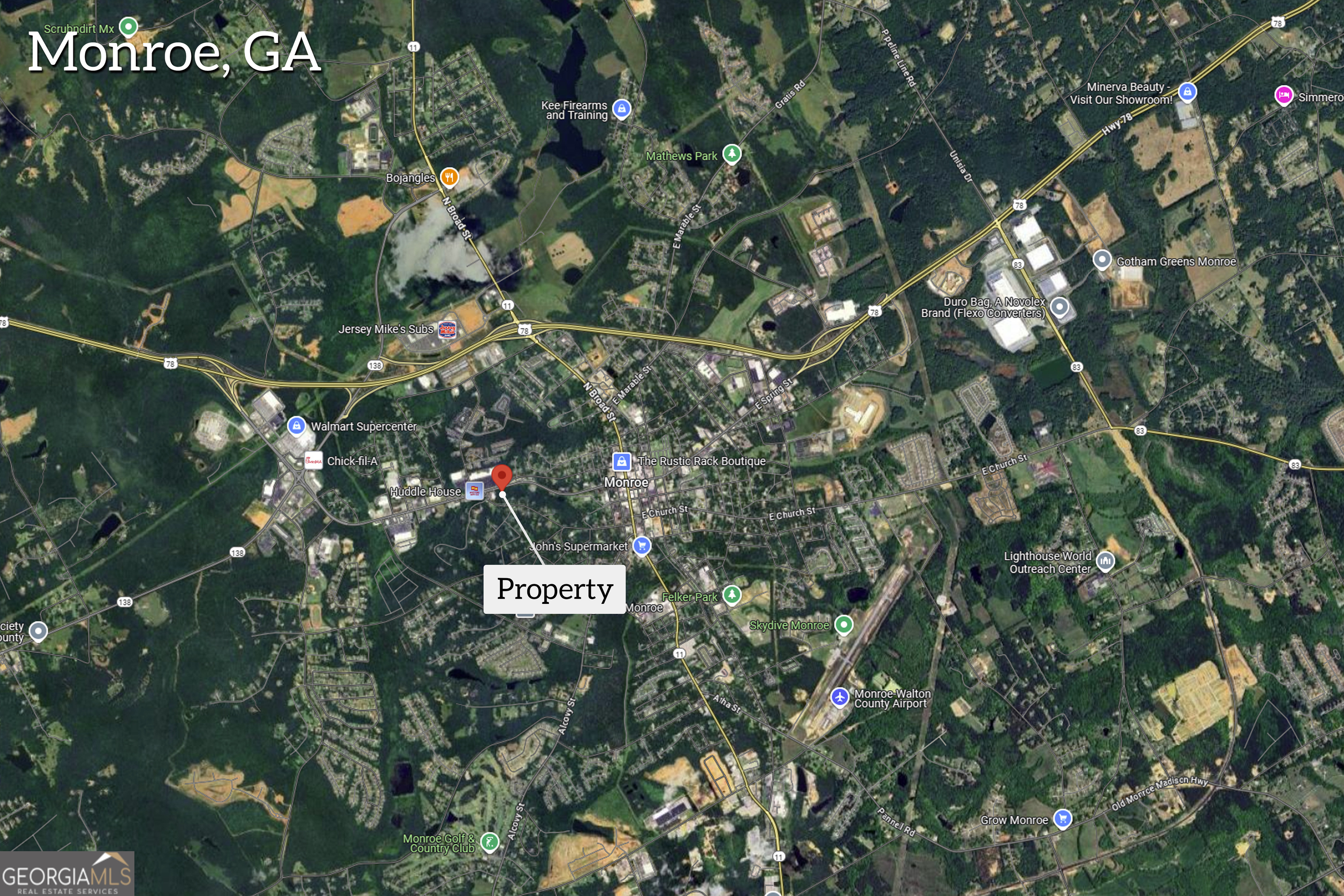 701 West Spring Street Monroe, GA 30655 - Photo 3 of 14 a sign that is sitting in a tree