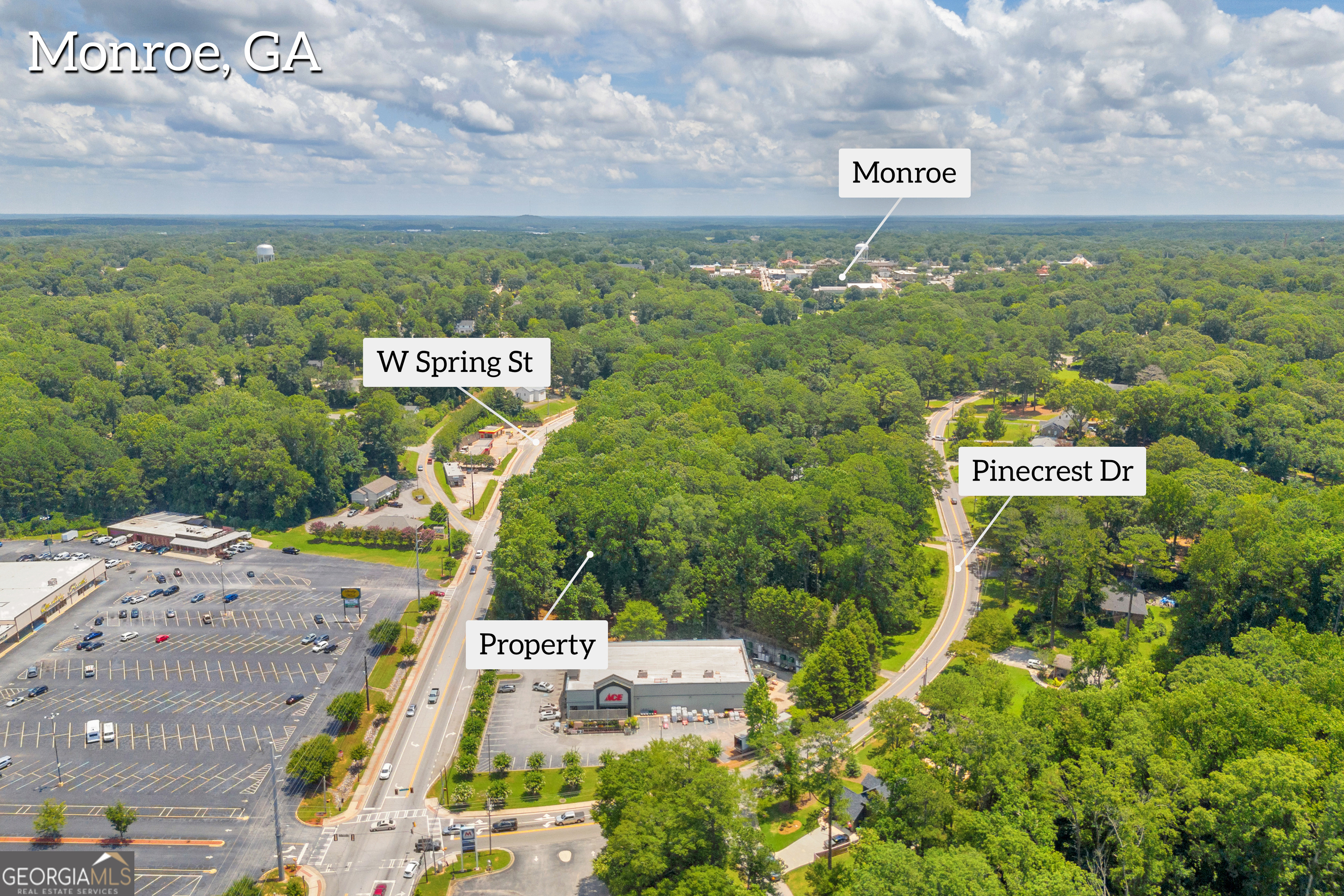 701 West Spring Street Monroe, GA 30655 - Photo 9 of 14 a sign that is sitting on a brick wall