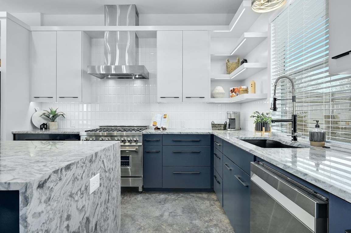 a kitchen with stainless steel appliances granite countertop a sink stove and cabinets