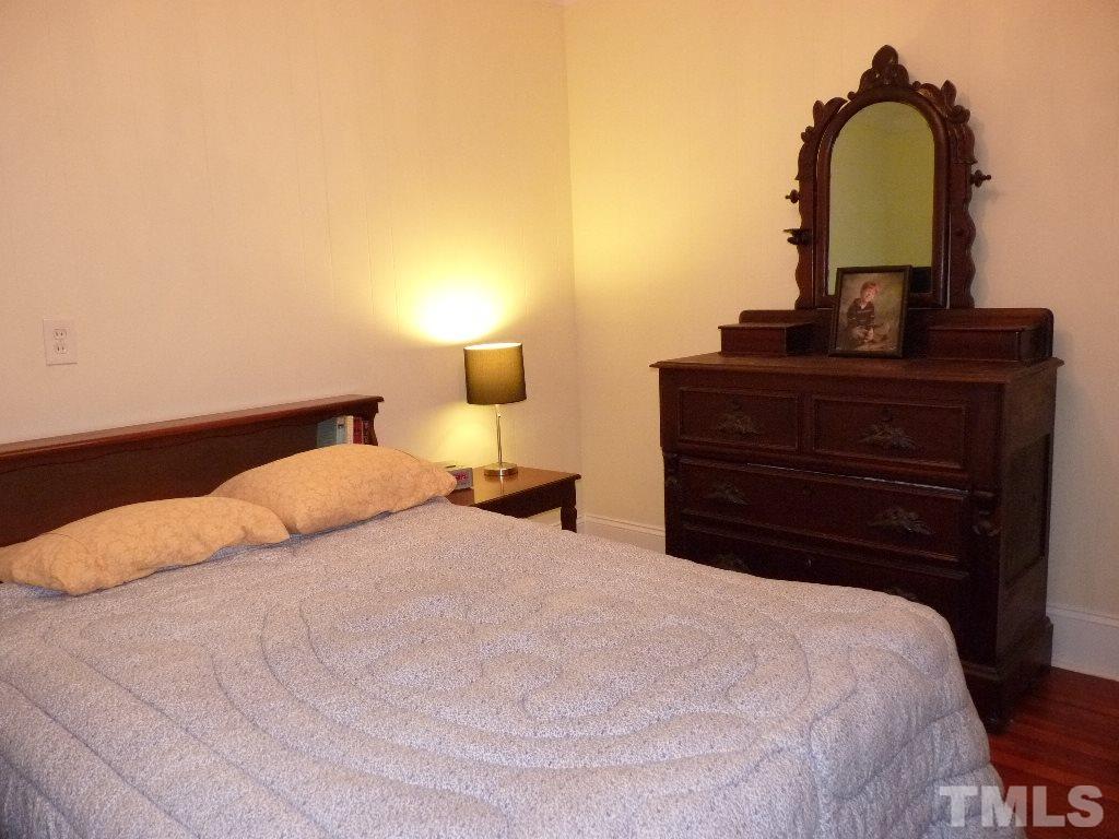 1324 Mordecai Drive Raleigh, NC 27604 - Photo 19 of 22 a bedroom with a bed and a lamp on dresser