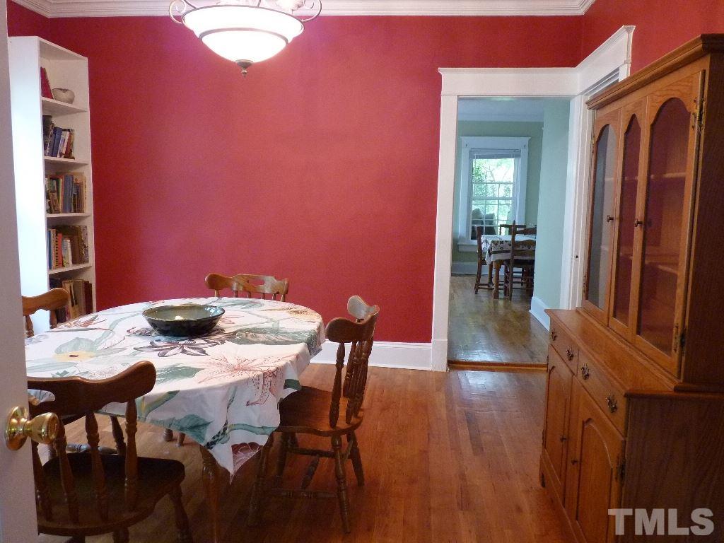 1324 Mordecai Drive Raleigh, NC 27604 - Photo 8 of 22 a view of a dining room with furniture and wooden floor