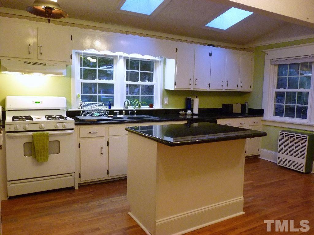 1324 Mordecai Drive Raleigh, NC 27604 - Photo 9 of 22 a kitchen with granite countertop a sink a counter space appliances and cabinets