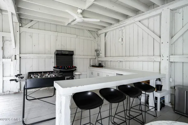 a kitchen with a dining table chairs and a refrigerator