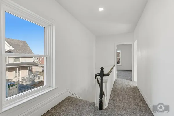 a view of a livingroom with a chair and front door