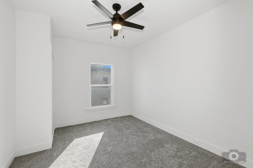 1009 Paul Street Ottawa, IL 61350 - Photo 14 of 25 an empty room with a window and a ceiling fan
