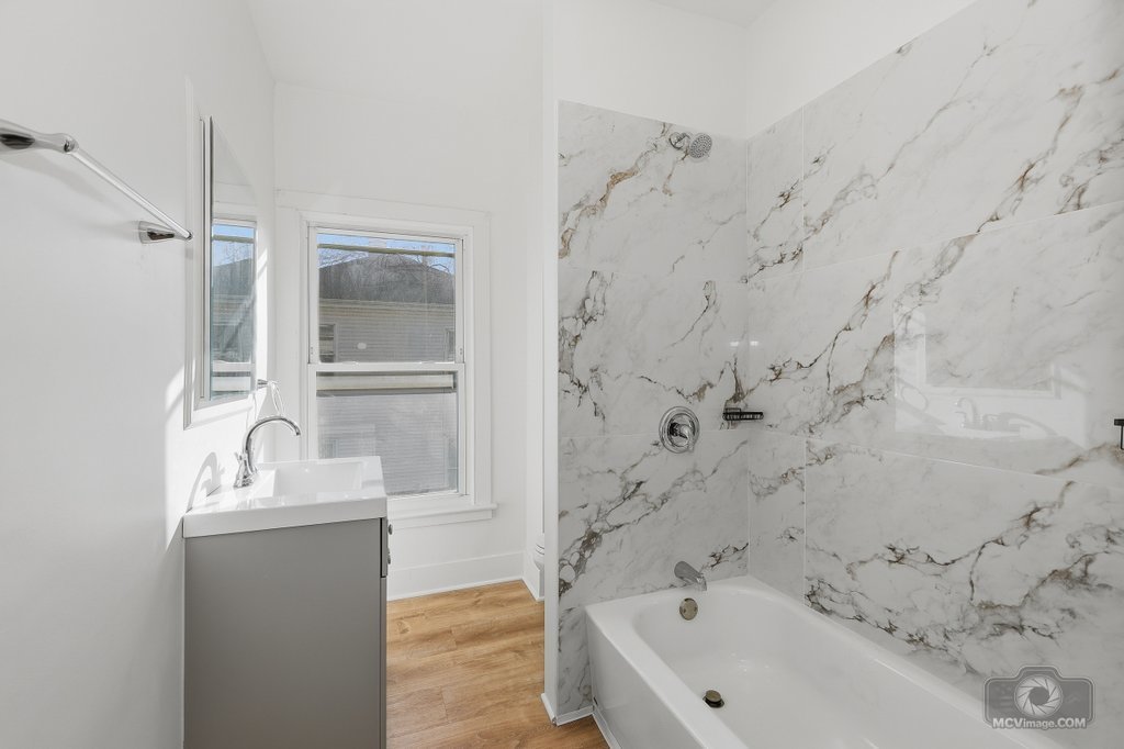 1009 Paul Street Ottawa, IL 61350 - Photo 17 of 25 a bathroom with a bathtub sink and mirror