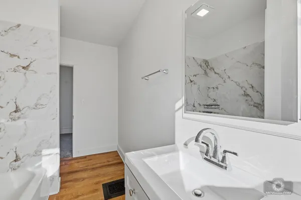 a bathroom with a sink and a mirror