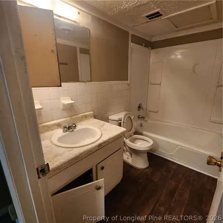 a bathroom with a toilet a sink and a mirror