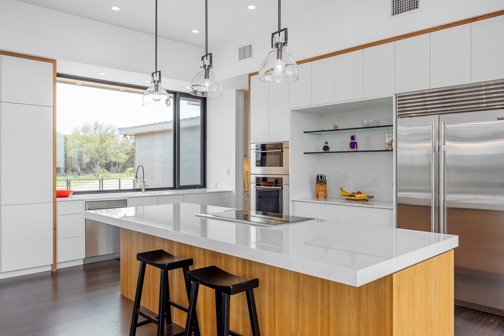 5081 Bandera Highway Center Point, TX 78010 - Photo 11 of 60 a kitchen with kitchen island a large counter top space and stainless steel appliances