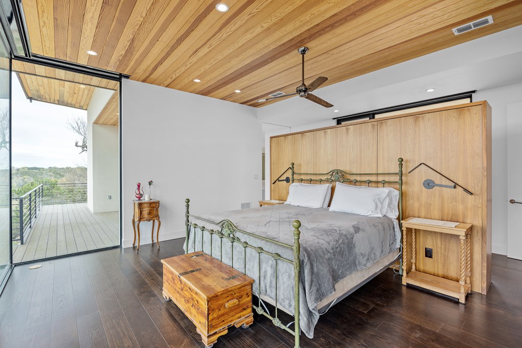 5081 Bandera Highway Center Point, TX 78010 - Photo 15 of 60 a bedroom with a bed and wooden floor