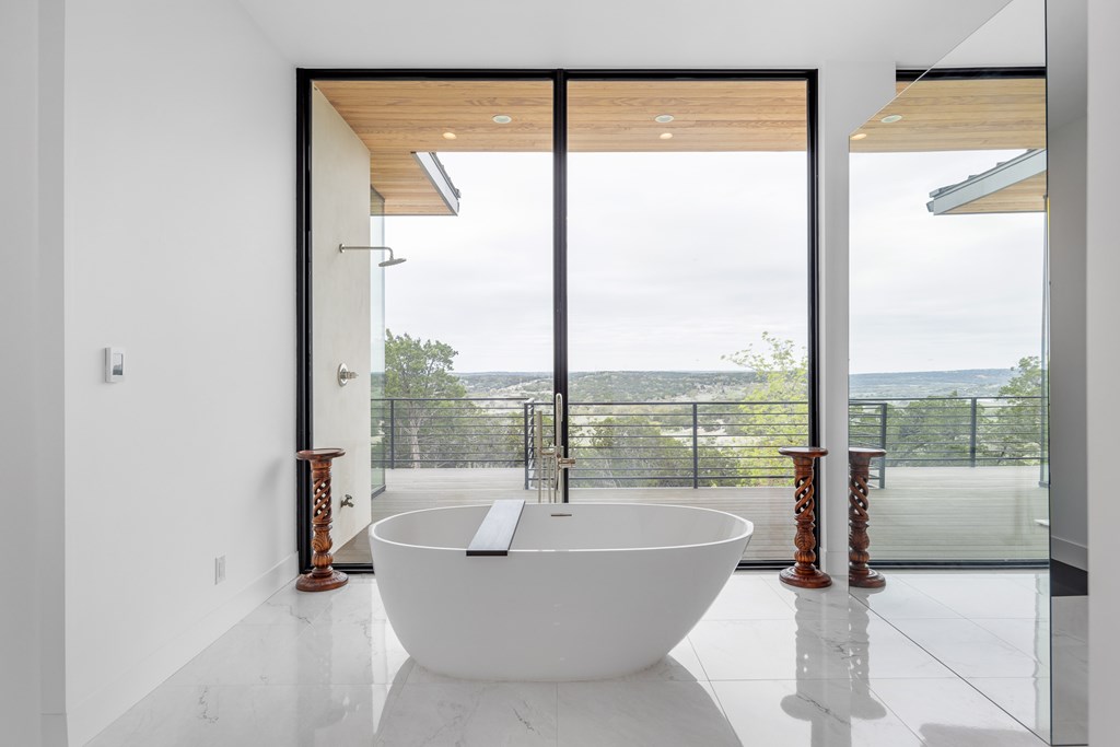 5081 Bandera Highway Center Point, TX 78010 - Photo 16 of 60 a living room with a large window and a table
