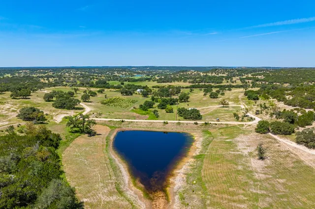 a view of a lush green outdoor space with a lake view