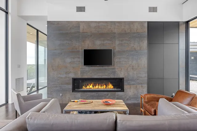 a kitchen with kitchen island a large counter top space and stainless steel appliances