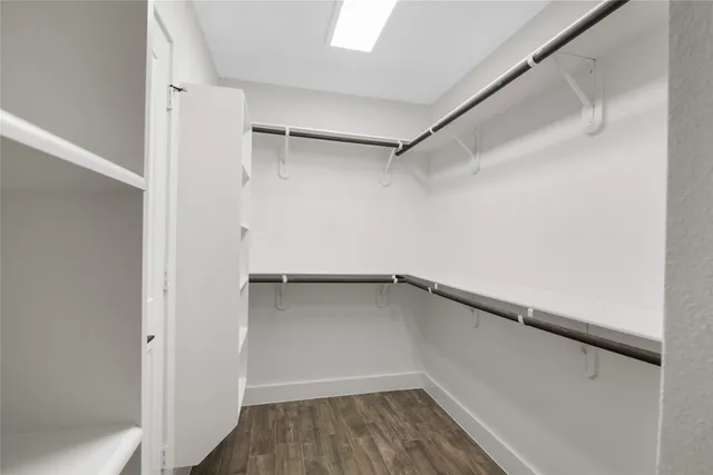 a view of a room with wooden floor