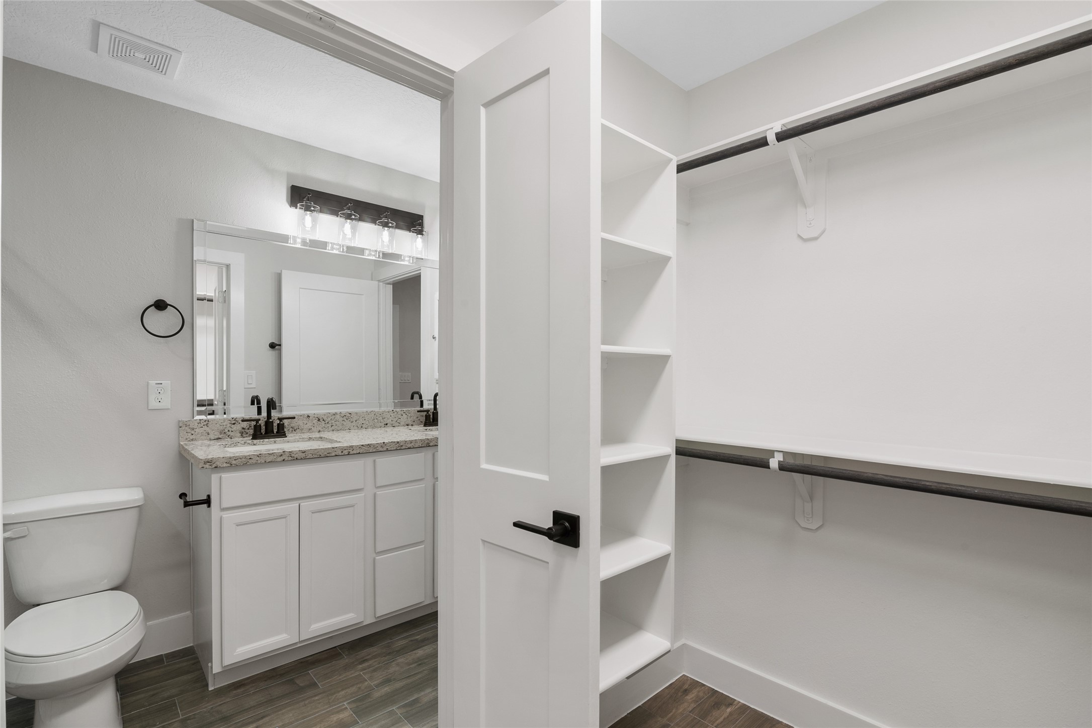 13018 Walden Road, Unit A Montgomery, TX 77356 - Photo 23 of 32 a bathroom with a granite countertop sink mirror vanity and toilet