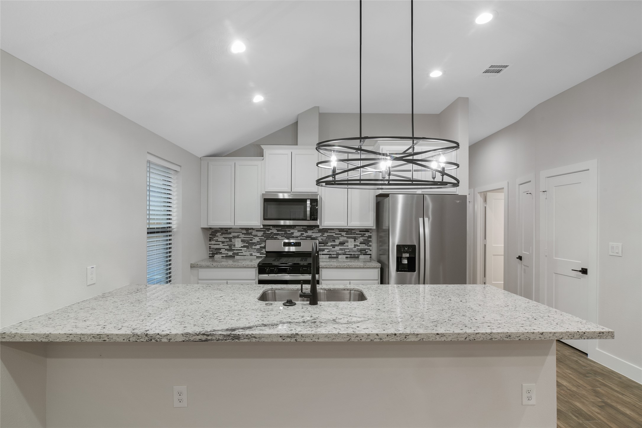 13018 Walden Road, Unit A Montgomery, TX 77356 - Photo 3 of 32 a kitchen with stainless steel appliances granite countertop a sink a stove and a refrigerator