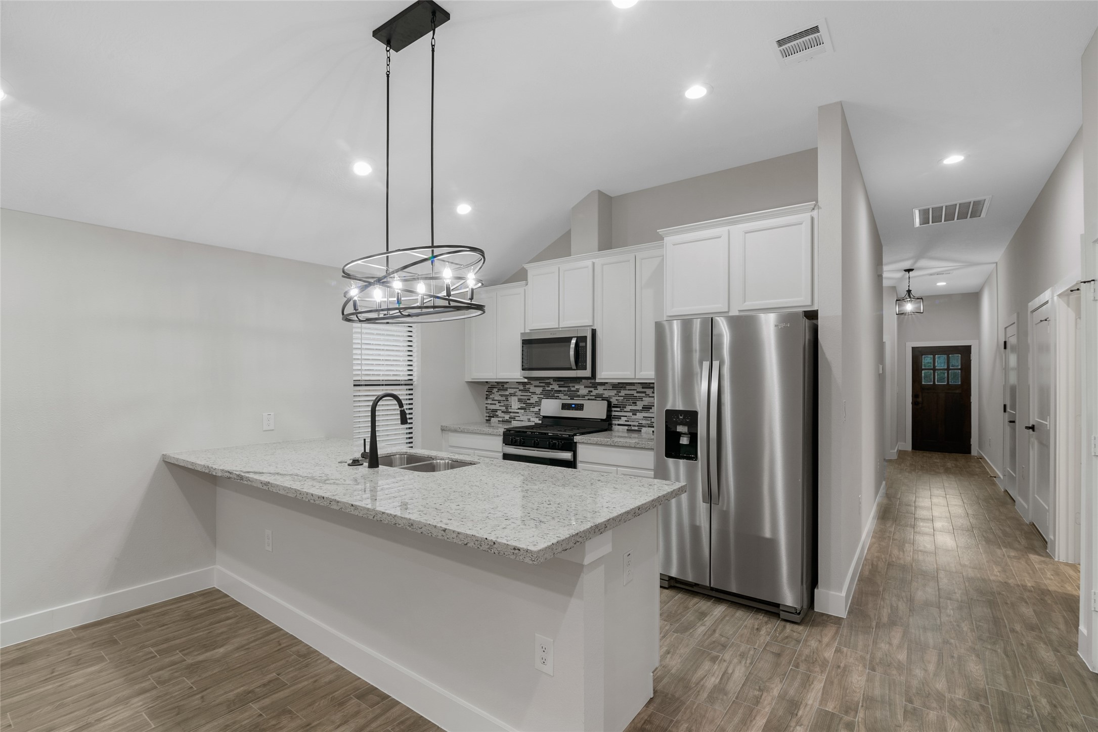 13018 Walden Road, Unit A Montgomery, TX 77356 - Photo 4 of 32 a kitchen with stainless steel appliances a refrigerator sink and microwave