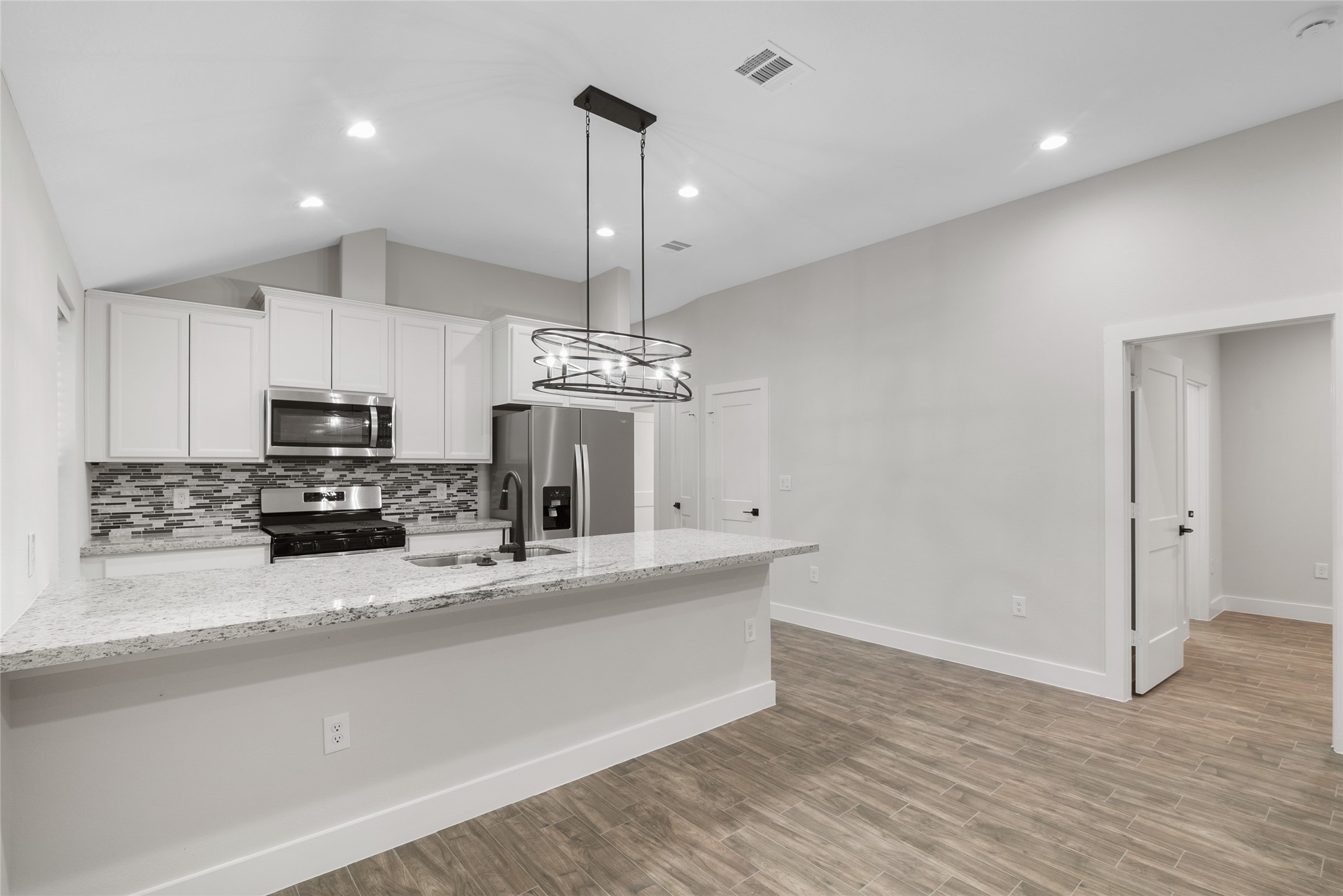13018 Walden Road, Unit A Montgomery, TX 77356 - Photo 5 of 32 a kitchen with stainless steel appliances a refrigerator sink and microwave