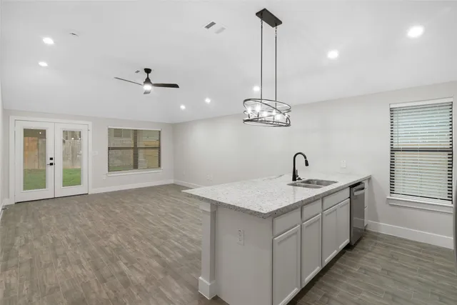 a kitchen with a sink chandelier and a stove