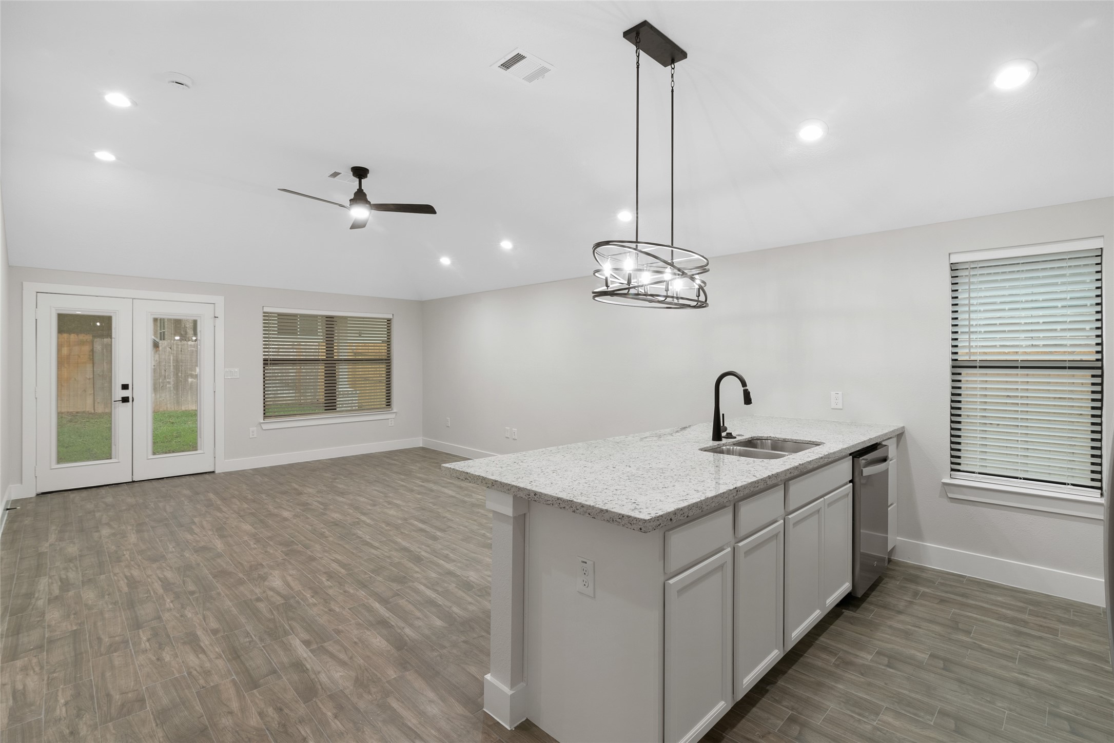 13018 Walden Road, Unit A Montgomery, TX 77356 - Photo 7 of 32 a kitchen with a sink chandelier and a stove