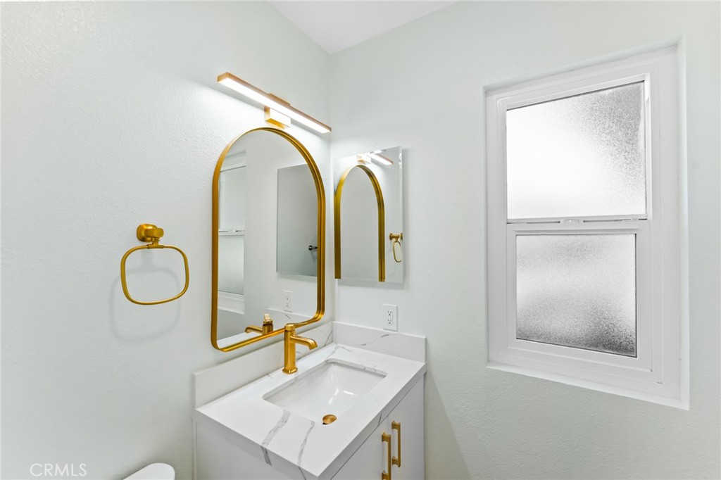 34381 Dana Strand Road, Unit 2 Dana Point, CA 92629 - Photo 19 of 32 a bathroom with a sink and a mirror