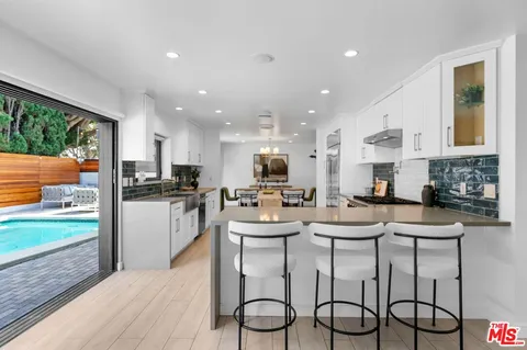 a kitchen with stainless steel appliances kitchen island granite countertop a sink and cabinets