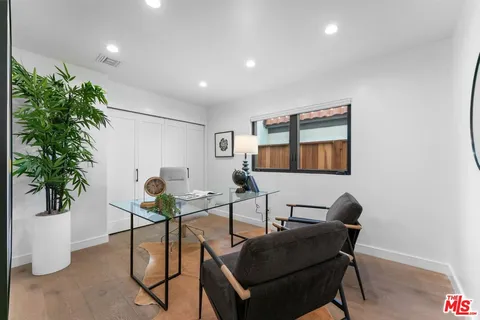 a living room with furniture and potted plant