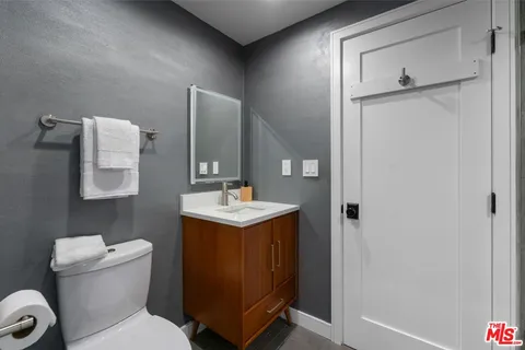 a bathroom with a toilet sink and mirror