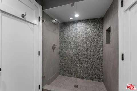 a bathroom with a shower and a sink