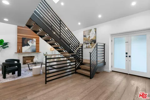 a view of entryway and hall with wooden floor
