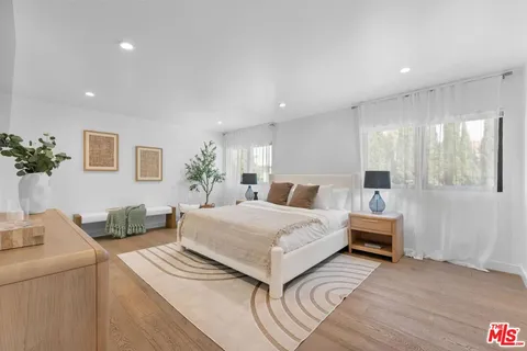 a spacious bedroom with a bed and a couch