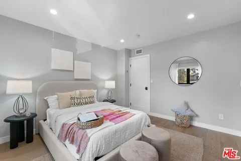 a bedroom with bed and a mirror