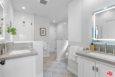 a bathroom with a sink and a large mirror