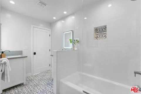 a bathroom with a bathtub and a toilet